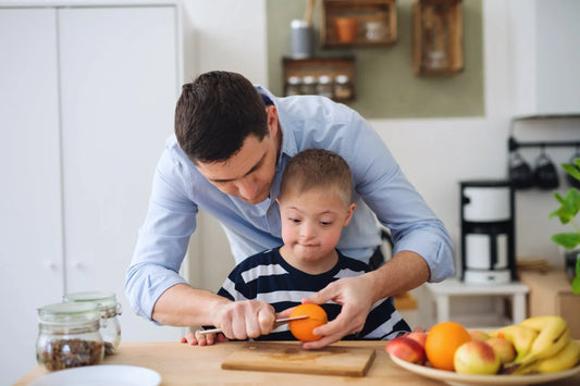 Papa qui aide son garçon à éplucher son orange.