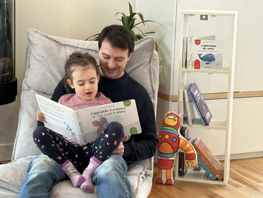 Père et fillette lisant le livre J'apprends à prononcer le son s avec la souris de Symbolicone